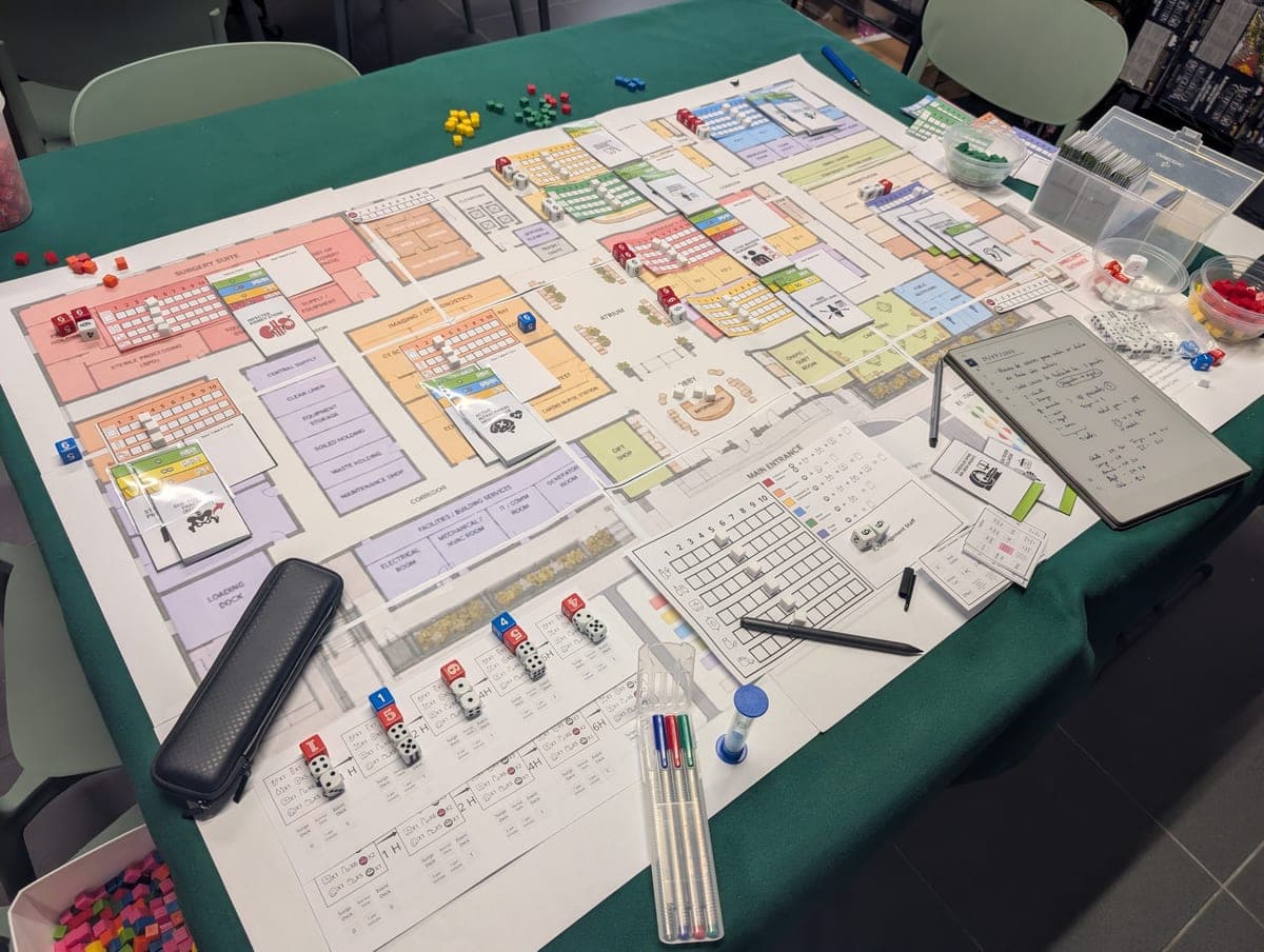 Hospital Surge tabletop game with patient tokens, staff pieces, and floor layout board