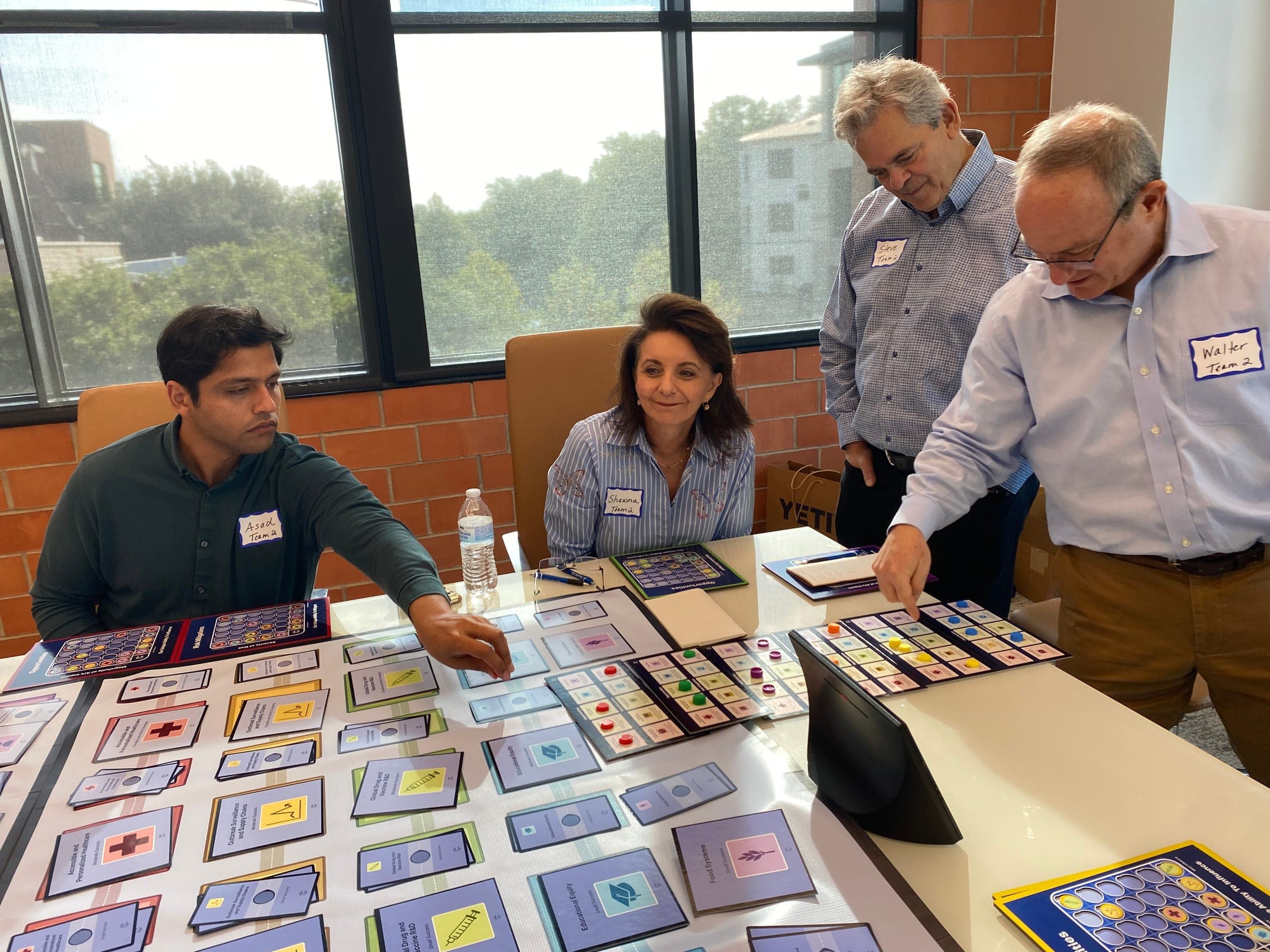 People gathered around a Strategic Prioritization game